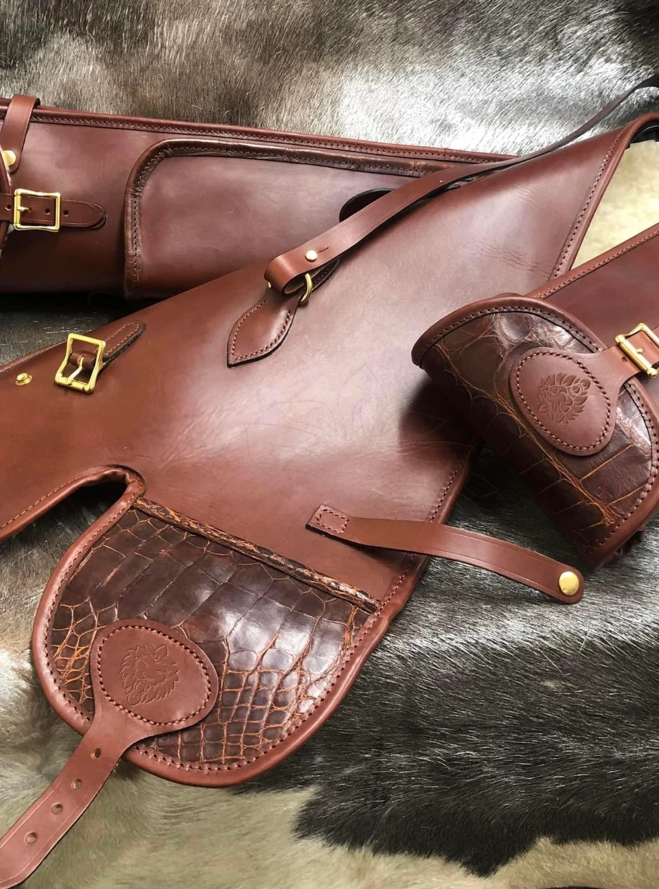 Embossed leather details and brass buckles.