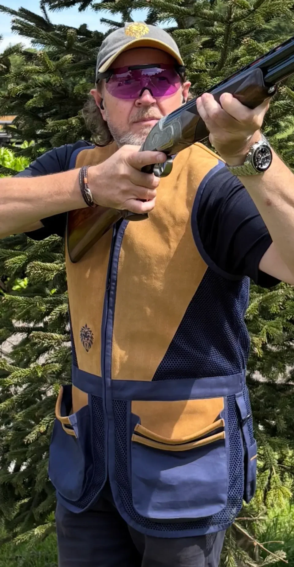 Brent wearing the Roar Sporting AmbiPro suede shooting vest while aiming his shotgun.